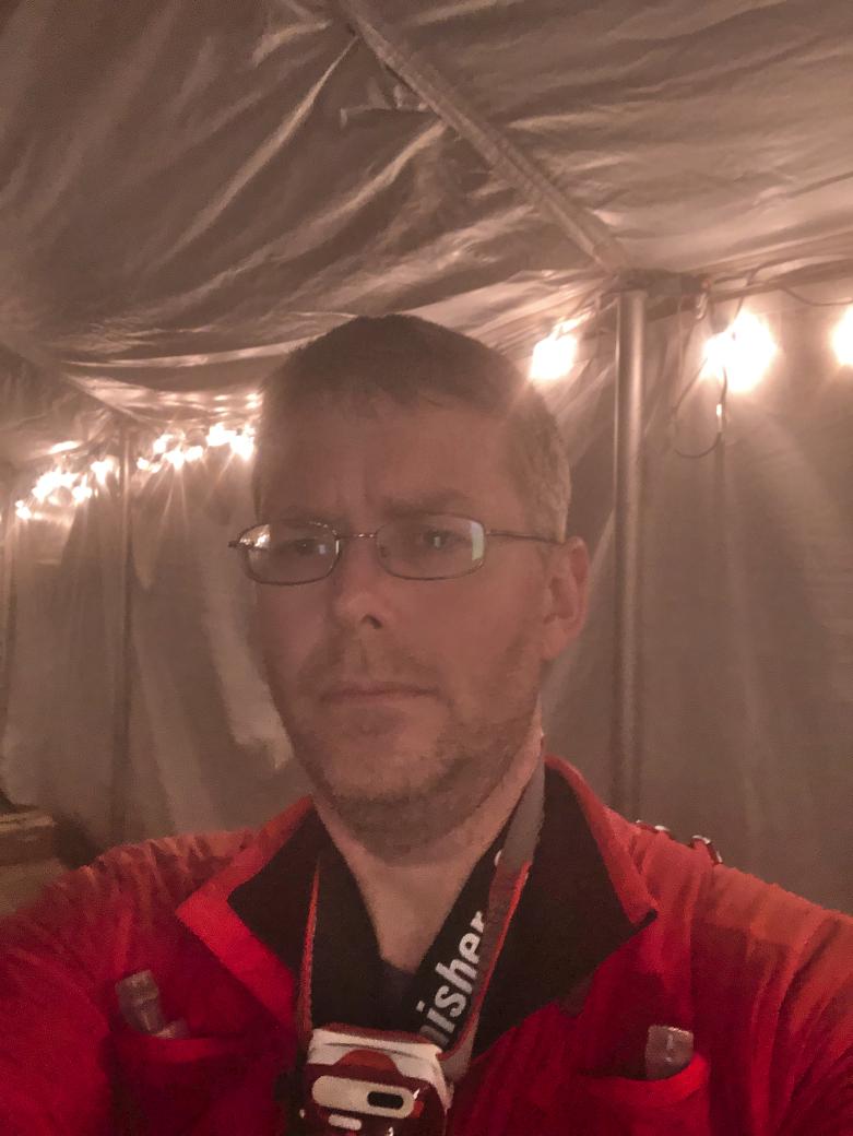 A picture of me, sitting in the tent at the finish line, looking completely exhausted.