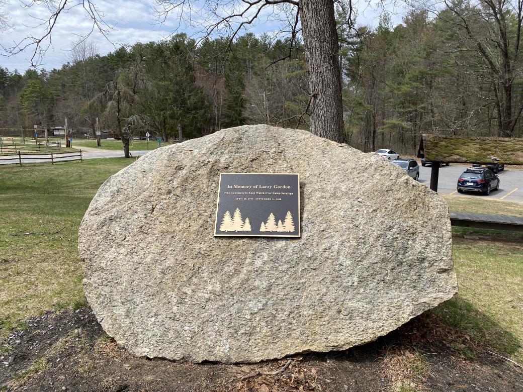 A plaque that reads: In Memory of Larry Gordon, Who Continues to Keep Watch Over Camp Saratoga, April 30th, 1935 to September 11th, 2018.